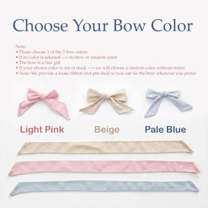 May include: Image shows three bow colors: light pink, beige, and pale blue. Each bow is displayed with a matching ribbon. Text at the top reads "Choose Your Bow Color." Additional text provides instructions for selecting a bow color.