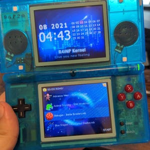 May include: A blue Nintendo DS handheld gaming console with a bright blue screen displaying a menu of games. The console has a red and black button pad and a stylus.