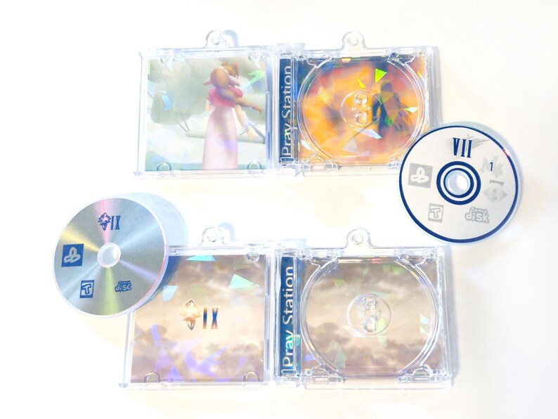 May include: A collection of PlayStation game discs and cases. The cases are clear plastic, and the discs have colorful graphics. The games appear to be Final Fantasy titles, with Roman numerals and the text "Pray Station" visible.