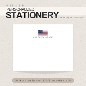 May include: Personalized stationery with a white background and a small American flag in the top center. The name "MATTHEW ADAMS" is printed in blue below the flag. The text "4.25 x 5.5" is printed in black at the top left corner. The text "PERSONALIZED STATIONERY" is printed in black at the top center. The text "envelopes included" is printed in black at the top right corner. The text "Printed on heavy, 130lb smooth stock" is printed in black at the bottom center.
