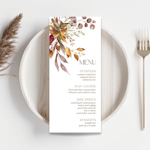 May include: A printable Thanksgiving menu with a watercolor floral design in shades of orange, yellow, and brown. The menu lists starters, main course, side dishes, and desserts.