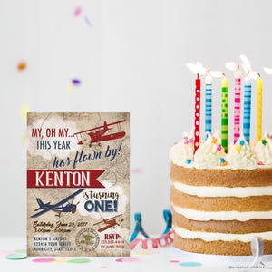 May include: A vintage-style airplane themed first birthday party invitation with a red and blue airplane graphic and the text "My, oh my... This year has flown by! Kenton is turning one!"  The invitation includes details for the party, including the date, time, location, and RSVP information.