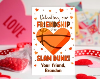May include: A white Valentine's Day card with an orange basketball-shaped heart. The card reads "Valentine, our FRIENDSHIP is a SLAM DUNK! Your friend, Brandon".
