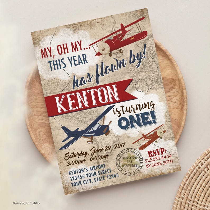 May include: A vintage-style airplane themed first birthday party invitation with a red, white, and blue color scheme. The invitation features a red airplane with a white propeller and a blue airplane with a white propeller. The text on the invitation reads "My, oh my... this year has flown by! Kenton is turning one!" and includes the date, time, and location of the party. RSVP information is also included.