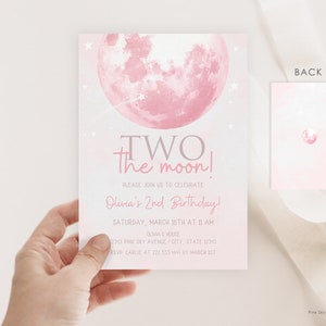 May include: Pink and gray invitation with a pink moon and stars. The text reads "TWO the moon! Please join us to celebrate Olivia's 2nd Birthday! Saturday, March 16th at 11 AM Olivia's House 12345 Pink Sky Avenue City, State 12345 RSVP Carlie at 222 333 1114 by March 1st"
