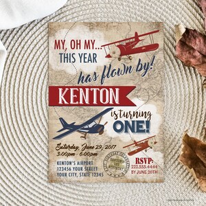 May include: A vintage-style airplane birthday invitation for a boy turning one year old. The invitation features a red and blue airplane with the text "My, oh my... This year has flown by! Kenton is turning one!" and a map background.