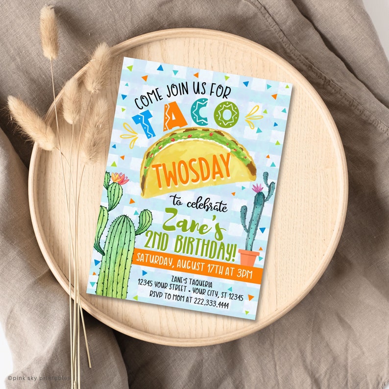 May include: A colourful invitation for a 2nd birthday party with a taco theme. The invitation features a cartoon taco with the text "Taco Twosday" and "Zane's 2nd Birthday!" The invitation also includes a cactus graphic and the text "Come Join Us For".