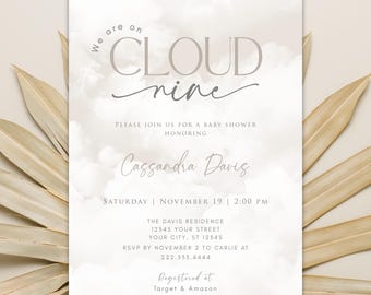 May include: A baby shower invitation with a cloud theme. The invitation is white with a gray watercolor background and the text "We are on Cloud nine" in gray. The invitation also includes the name "Cassandra Davis" and the date and time of the shower.
