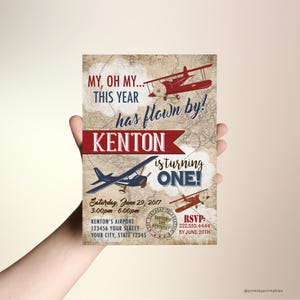 May include: A vintage-style airplane birthday invitation with a red and blue airplane flying over a map. The text reads "My, oh my... this year has flown by! Kenton is turning one!" with details for the party, including the date, time, location, and RSVP information.
