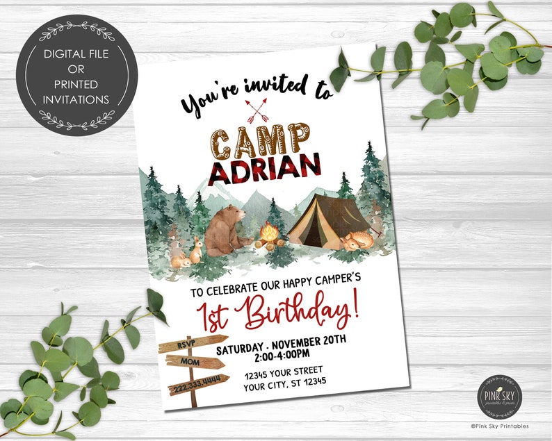 May include: A woodland-themed first birthday party invitation with a red and black plaid design. The invitation features a bear, a tent, and a campfire. The text reads "You're invited to Camp Adrian to celebrate our happy camper's 1st Birthday!"