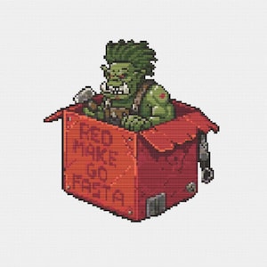 May include: A green, pixelated orc holding a hammer, sitting inside a red box with the words "RED MAKE GO FASTA" printed on it.