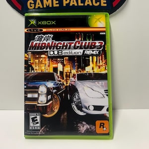 May include: An Xbox game case for Midnight Club 3: DUB Edition Remix. The game case features a nighttime cityscape with two cars. The game case is in a green case with the Xbox logo. The game is rated E for Everyone.