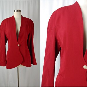May include: A red blazer with a deep V-neck and a single gold button closure. The blazer has a fitted silhouette and long sleeves.