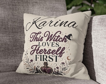 May include: A square off-white throw pillow featuring the name Karina in black script at the top. Below, dark purple text reads This Witch LOVES Herself FIRST, accompanied by a small witch hat, a crescent moon, and a potion bottle with floral accents.
