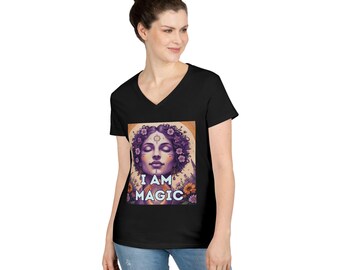 May include: Black V-neck t-shirt featuring a colorful graphic of a woman with closed eyes, surrounded by flowers. The text "I AM MAGIC" is below the image. The model is wearing blue jeans.