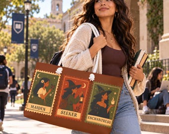 May include: A brown tote bag featuring three rectangular stamp-style illustrations. The left panel shows a person with a butterfly labeled MAIDEN. The center panel shows a person with a lantern labeled SEEKER. The right panel shows a person with a flame labeled ENCHANTRESS.