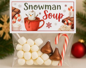 May include: A clear cellophane bag filled with marshmallows, chocolate candies, and a candy cane. The bag is topped with a card that reads "Snowman Soup" with illustrations of hot cocoa and a snowman.