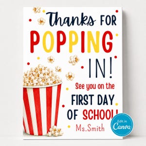 May include: A rectangular sign with a white background featuring a red and white striped popcorn bucket filled with popcorn. The text reads: Thanks FOR POPPING IN! See you on the FIRST DAY OF SCHOOL Ms. Smith. Small yellow and red dots are scattered.