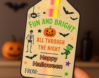 May include: A rectangular Halloween gift tag with rounded top corners, featuring a cream background, neon pink and yellow glow sticks, and illustrations of a pumpkin, skeleton, and monster. Text reads: FUN AND BRIGHT ALL THROUGH THE NIGHT Happy Halloween FROM:.