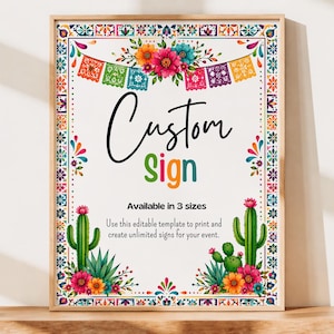 May include: A framed custom sign with a colorful floral and geometric border. The sign features the words "Custom Sign" in black and green, with text below stating it's available in 3 sizes. Cacti and flowers decorate the bottom.