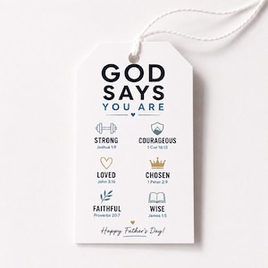 May include: A white rectangular gift tag with a string loop featuring the text GOD SAYS YOU ARE and six icons with corresponding words and Bible verses: STRONG, COURAGEOUS, LOVED, CHOSEN, FAITHFUL, and WISE. The bottom text reads Happy Father's Day!