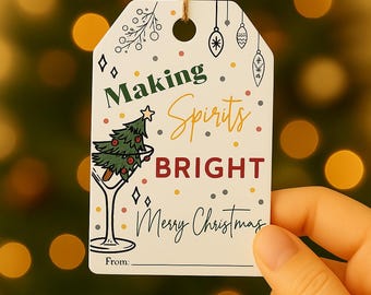 May include: A white Christmas gift tag with the text "Making Spirits Bright" and "Merry Christmas" in a festive font. The tag features a Christmas tree in a martini glass and decorative ornaments.