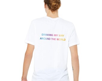 May include: White t-shirt with a rainbow gradient design that reads "Drinking My Way Around The World".