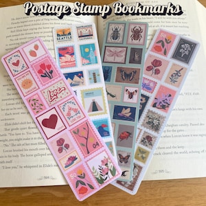 May include: Four decorative bookmarks featuring postage stamp designs with floral, heart, and travel motifs. The bookmarks are displayed on an open book, with the text "Postage Stamp Bookmarks" visible at the top.