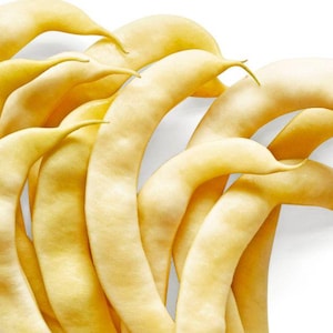 Può includere: Primo piano di diversi fagiolini gialli, disposti in un motivo curvo su sfondo bianco. I fagiolini hanno una consistenza liscia e una leggera curva, con una punta all'estremità di ogni fagiolino. Il colore è giallo pallido.