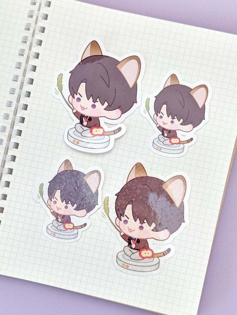 May include: Four stickers featuring a cartoon character with cat ears, holding a green sprig. The character is wearing a dark red jacket and sitting on a white and gray platform. The stickers are on a grid-lined notebook page.
