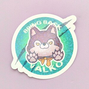 May include: A circular sticker featuring a cartoon wolf with purple fur, yellow eyes, and a yellow necktie. The wolf has its paws raised against a teal and green holographic background with black claw marks and the text BRING BACK VALKO.