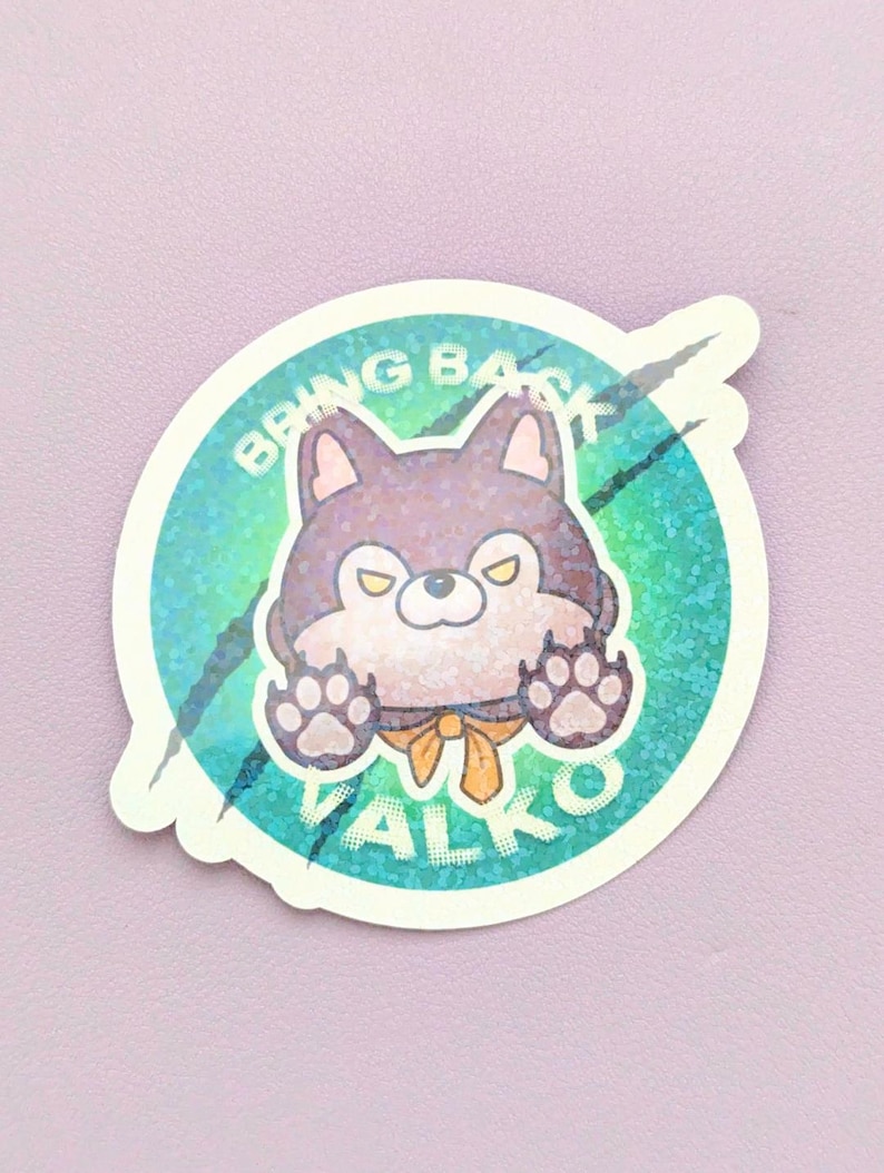 May include: A circular sticker featuring a cartoon wolf with purple fur, yellow eyes, and a yellow necktie. The wolf has its paws raised against a teal and green holographic background with black claw marks and the text BRING BACK VALKO.