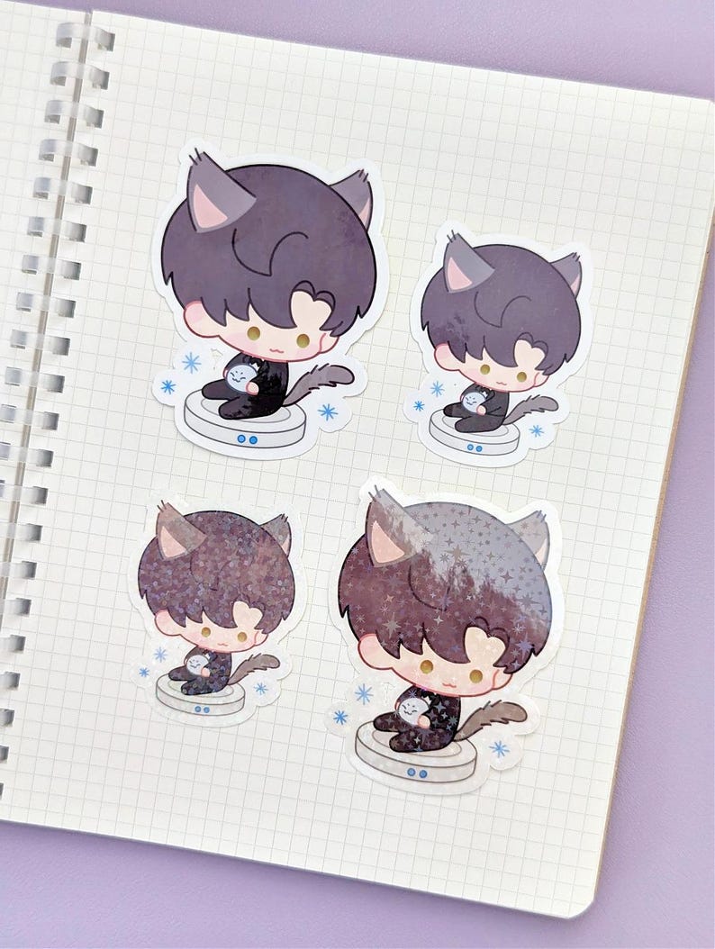 May include: Four stickers featuring a cartoon character with cat ears and dark hair. The character is holding a small, round object and sitting on a circular platform. Each sticker has a different pattern on the hair. Blue snowflakes surround the platform.