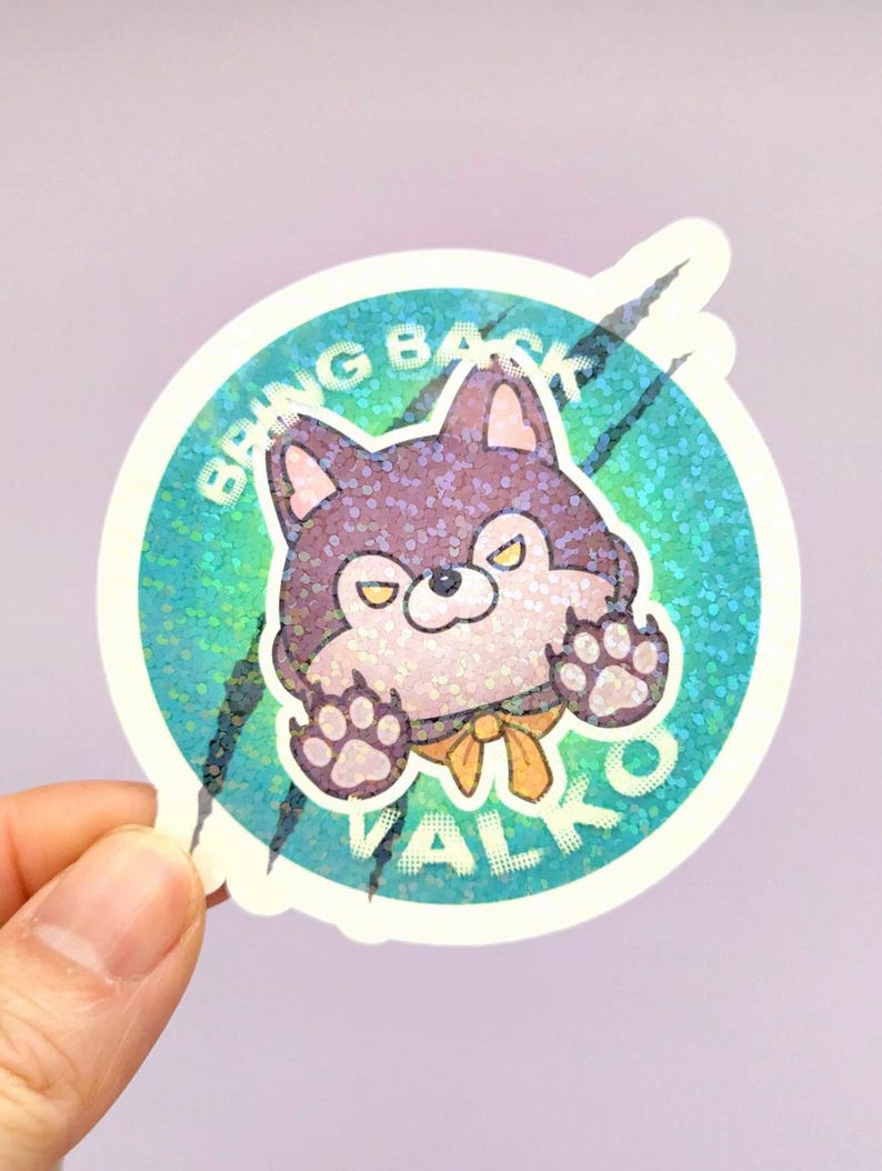 May include: A circular holographic sticker featuring a cartoon purple wolf character with yellow eyes and a yellow neck ribbon. The background is a teal gradient with black claw marks and the white text BRING BACK VALKO arched around the wolf.