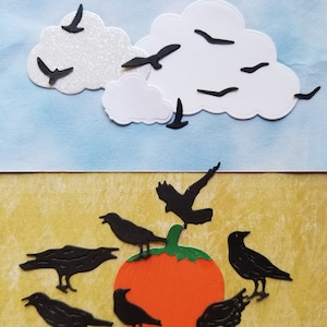 May include: A black pumpkin with a green stem surrounded by black crows on a yellow background.  There are black crows flying in a white cloud against a blue sky.