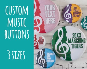 May include: Custom music buttons featuring a treble clef design. The buttons are available in three sizes and feature different text, including "Your Text Here", "ISU Mellos 20XX", "Shermer High Band Boosters", "Hill Valley Trumpet Section", and "20XX Marching Tigers".