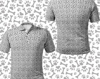 May include: A white polo shirt with a black paw print and bone pattern. The shirt has short sleeves and a collared neckline. The background features a repeating pattern of gray paw prints and bones.