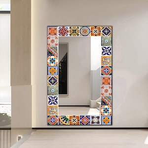 May include: A rectangular wall mirror featuring a decorative frame composed of various square tiles. Each tile displays a unique, colorful geometric or floral pattern in shades of blue, orange, yellow, green, and red, creating a vibrant border.