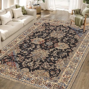 May include: A black and cream patterned area rug with a floral design. The rug has a detailed border with a cream background and a black floral pattern.