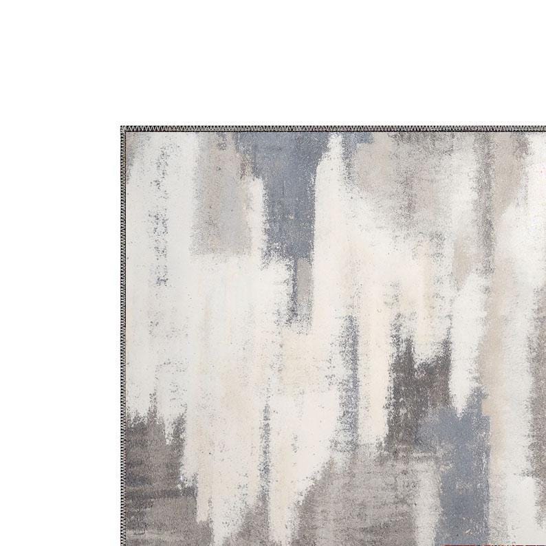 May include: Abstract area rug with a textured design. The rug features a blend of white, gray, and blue hues, creating a modern, artistic aesthetic. The edges are finished with a dark border.