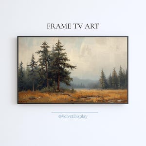 May include: A framed landscape painting depicting a forest scene with tall evergreen trees and a field of golden grass. The artwork has a vintage aesthetic, with the text "FRAME TV ART" at the top and "@VelvetDisplay" at the bottom.