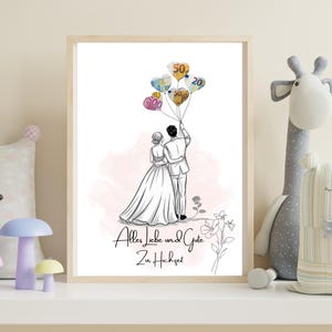 May include: A framed illustration depicts a couple embracing, with heart-shaped balloons made of currency. The artwork is in black and white, with a soft pink background. The text "Alles Liebe und Gute Zur Hochzeit" is written in cursive.