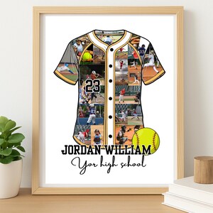 May include: Framed baseball jersey art with a collage of baseball action photos. The jersey is white with black and gold trim and the number 23. A yellow softball is next to the jersey. The text reads "JORDAN WILLIAM Your high school."
