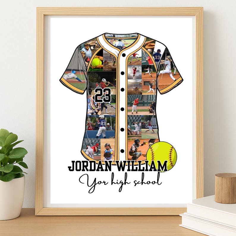 May include: Framed baseball jersey art with a collage of baseball action photos. The jersey is white with black and gold trim and the number 23. A yellow softball is next to the jersey. The text reads "JORDAN WILLIAM Your high school."