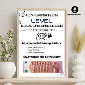 Könnte beinhalten: Ein gerahmter Druck mit dem Text "KONFIRMATION LEVEL ERWACHSENWERDEN - FREIGESCHALTET-". Darunter eine Grafik eines Gamecontrollers und ein Schloss. Der Druck enthält auch den Text "Mission: Selbstständig & Stark" und eine 10-Euro-Banknote.