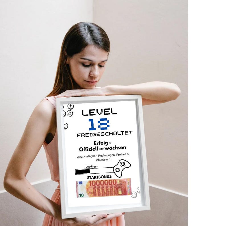 May include: A white framed print featuring the text "LEVEL 18 FREIGESCHALTET" in black and blue pixelated font. The print includes a graphic of a game controller and a stack of Euro banknotes. The text translates to "Level 18 Unlocked".
