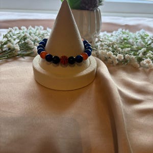 New York Knicks-inspirerat armband med kattögonmotiv