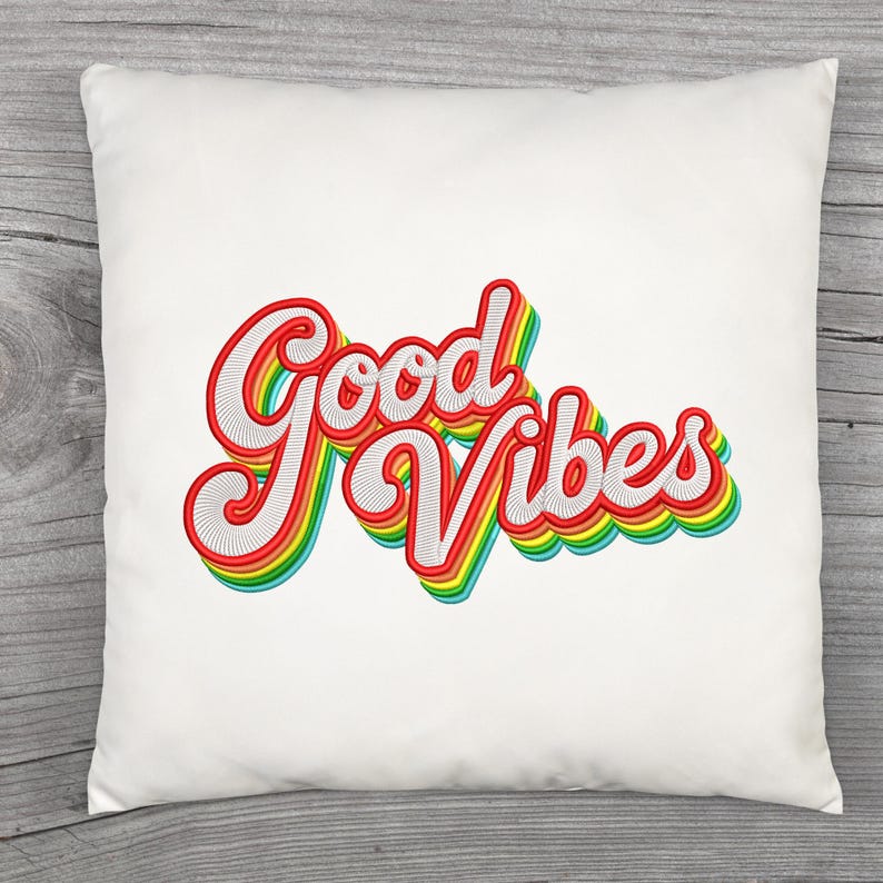 May include: A square white cushion featuring the embroidered words "Good Vibes" in a retro style. The text is outlined in red with a white centre and a rainbow shadow, creating a bright and cheerful design.