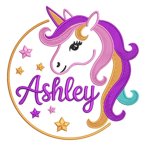 May include: A whimsical embroidered design featuring a unicorn head with a purple mane and a golden horn, surrounded by stars and a gold circle. The name "Ashley" is written in purple script below the unicorn.