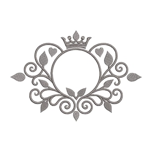 May include: A gray embroidered design featuring a crown above a circular frame. The frame is surrounded by decorative leaves, hearts, and swirling patterns, creating an elegant, symmetrical emblem.